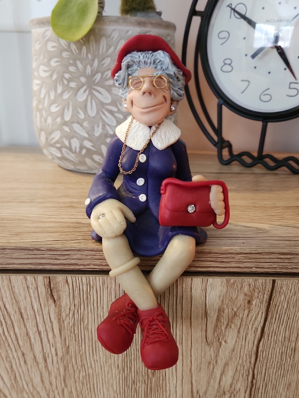 Whimsical Sitting Lady Figurine with Red Purse